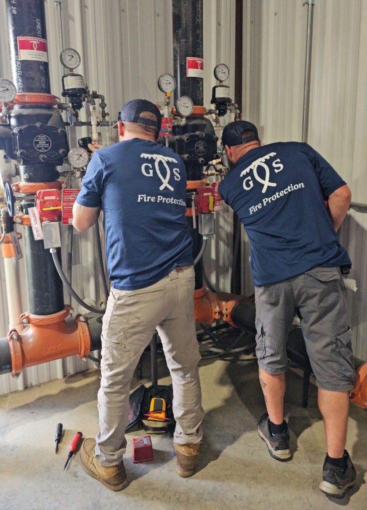 GS Fire Protection technicians inspecting a fire sprinkler riser